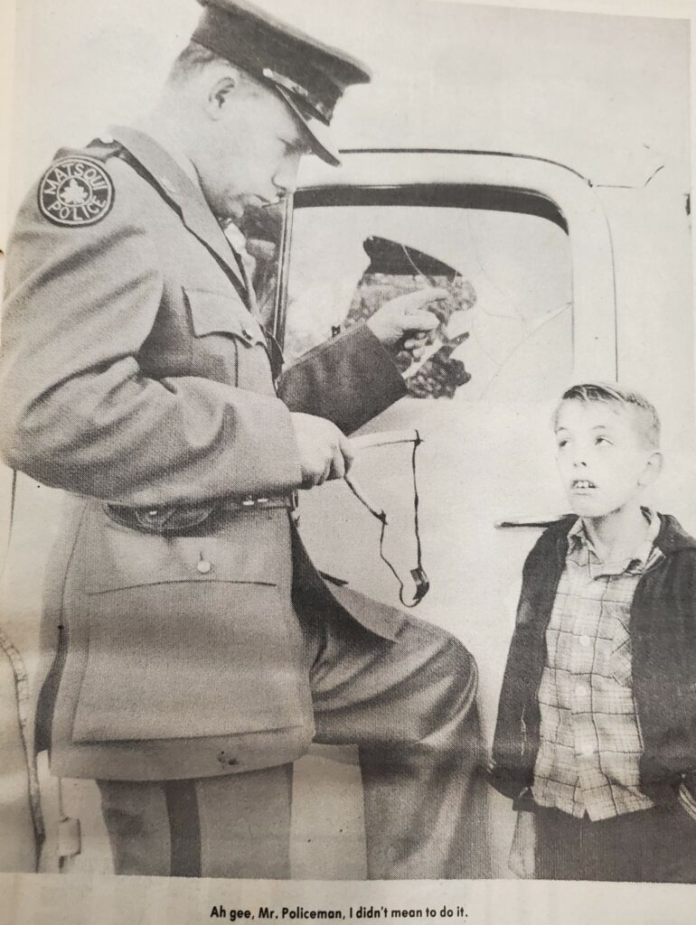 Photo of a policeman wagging his finger at a boy about a broken car window. The caption reads "Ah gee, Mr. Policeman, I didn't mean to do it."